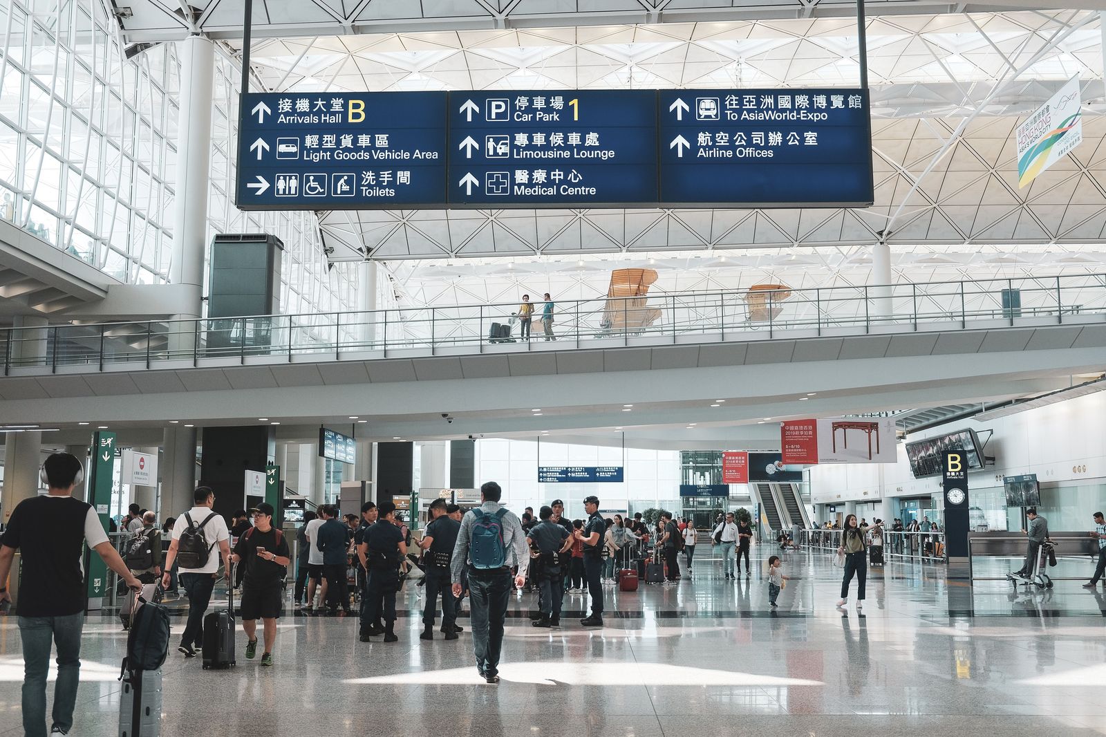 The pre-arranged area at the arrivals door: a door number and a chauffeur who is already there