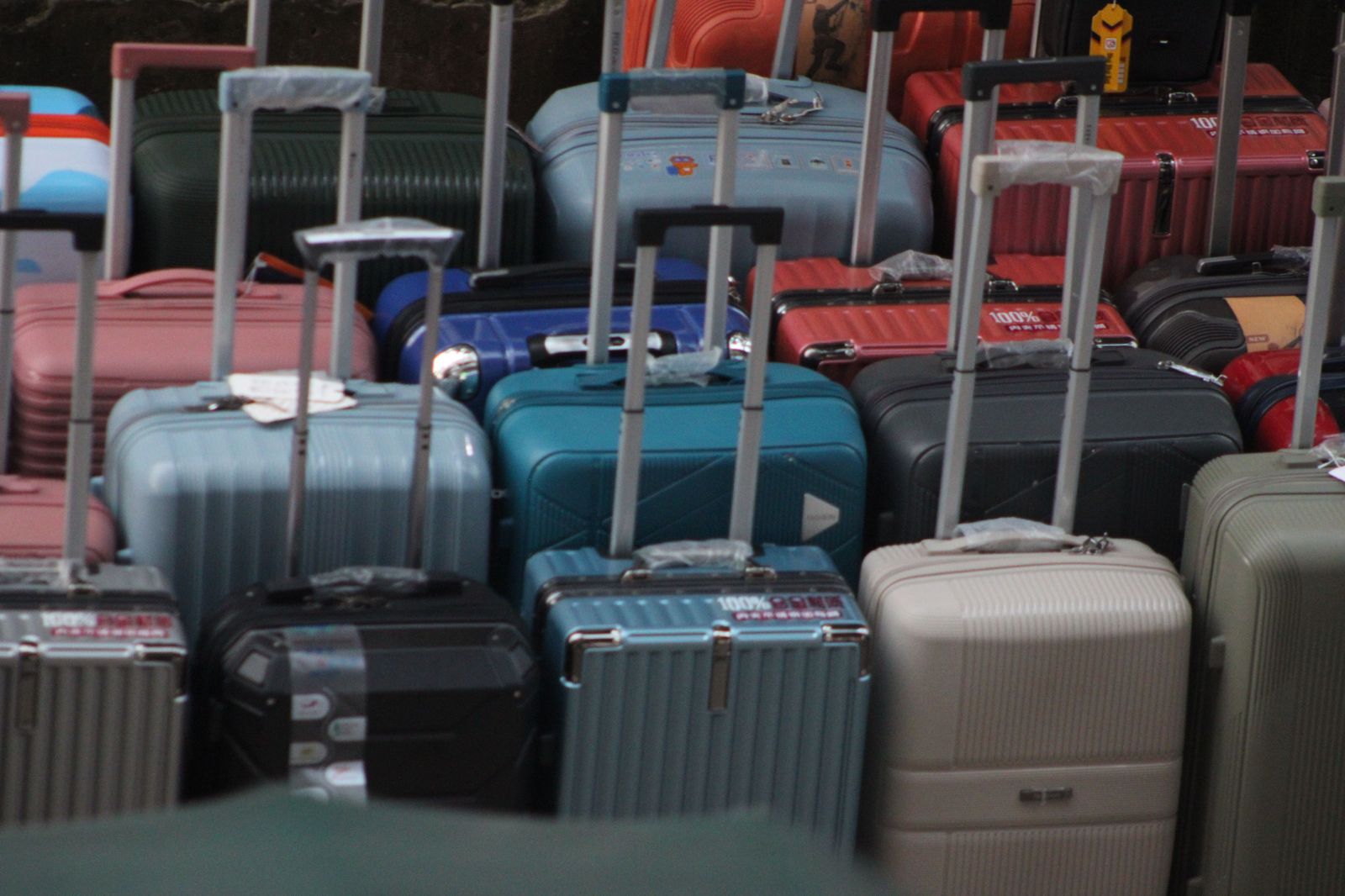 A group and its luggage at the curb — the moment one vehicle beats four