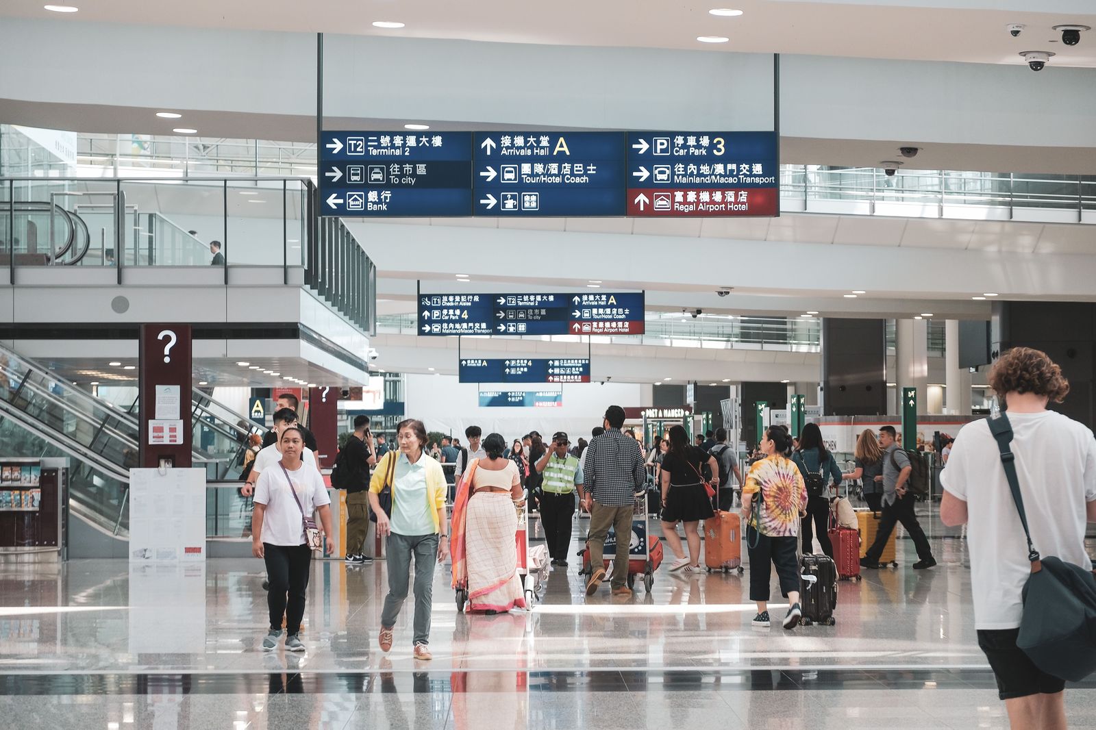 A chauffeur meeting an arriving passenger in the Pearson arrivals hall, the alternative to a waiting-lot pickup